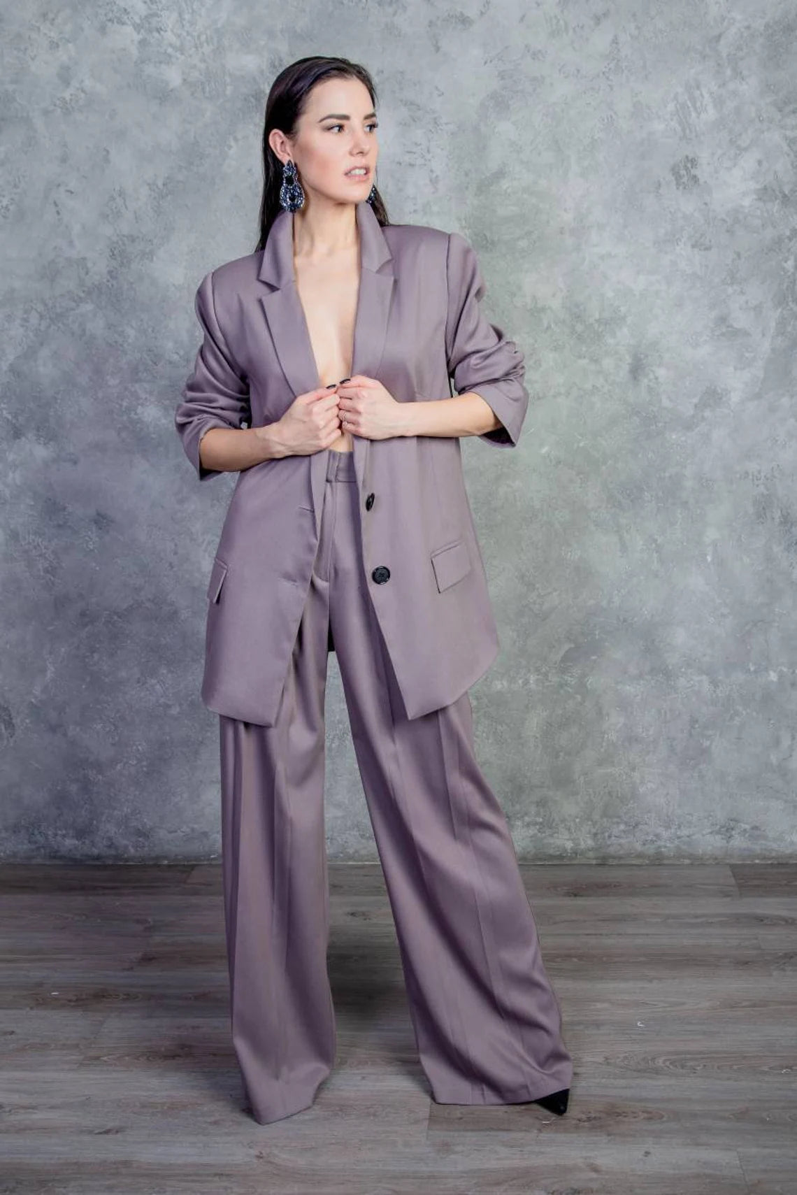Suit. Women trouser suit. Trousers with pleats on the front and